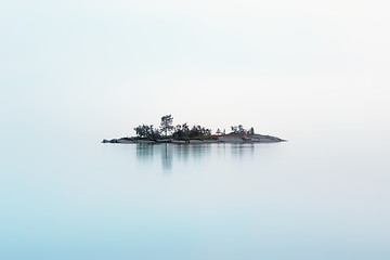 Image showing Remote Island Hanging In The Fog Over The Northern Lake