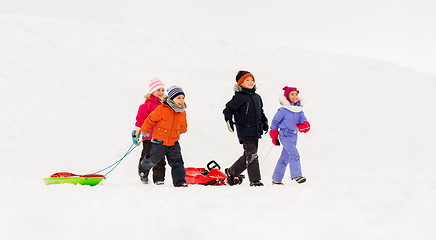 Image showing happy little kids with sleds in winter