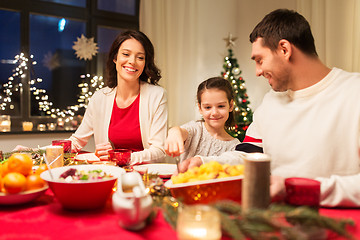 Image showing happy family having christmas dinner at home