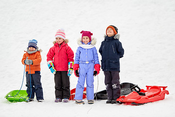 Image showing happy little kids with sleds in winter