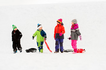 Image showing happy little kids with sleds in winter