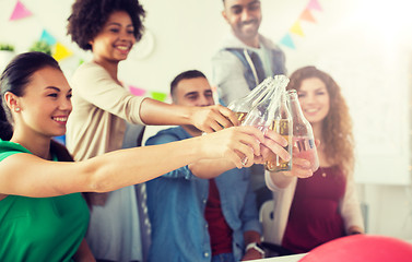 Image showing happy team with drinks celebrating at office party