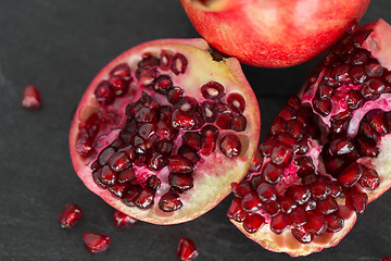 Image showing close up of pomegranate on stone table