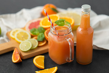 Image showing mason jar glass of fruit juice on slate table top