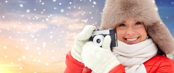 Image showing happy woman with film camera outdoors in winter