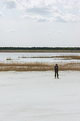Image showing Man Standing By The Lake Among White Quartz Sand 