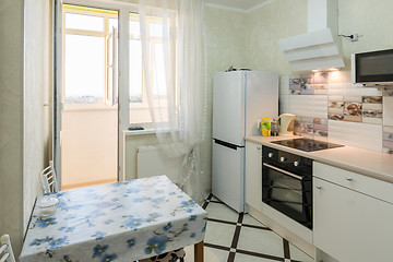 Image showing The interior of a small kitchen with a balcony