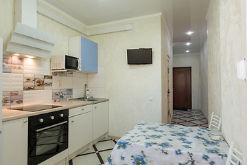 Image showing The interior of a small kitchen and corridor leading to the exit