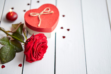 Image showing Fresh red rose flower on the white wooden table