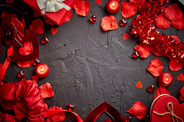 Image showing Red roses petals, candles, dating accessories, boxed gifts, hearts, sequins