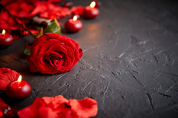 Image showing Red rose, petals, candles, dating accessories, boxed gifts, hearts, sequins