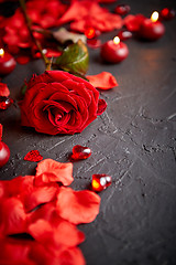 Image showing Red rose, petals, candles, dating accessories, boxed gifts, hearts, sequins