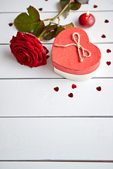 Image showing Fresh red rose flower on the white wooden table