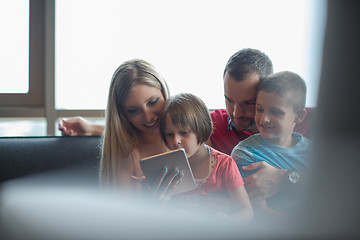 Image showing happy young couple spending time with kids