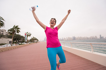 Image showing young woman celebrating a successful training run