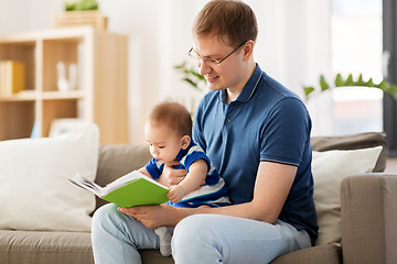 Image showing happy father and little baby son with book at home