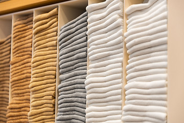 Image showing close up of shelves with clothes at clothing store