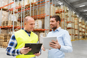 Image showing worker and businessman with tablet pc at warehouse