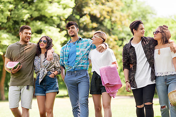 Image showing happy friends with picnic blanket at summer park