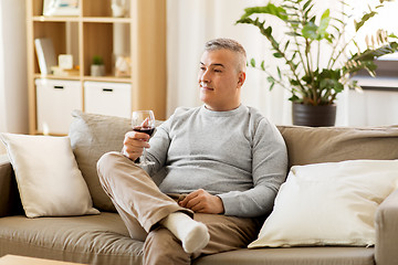 Image showing man drinking red wine from glass at home