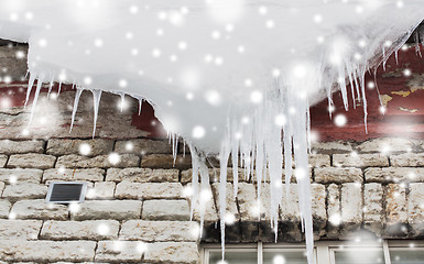 Image showing icicles and snow hanging from building roof