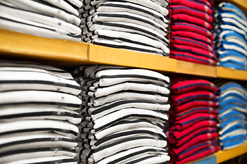 Image showing close up of shelves with clothes at clothing store