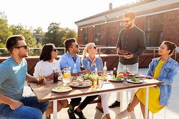 Image showing friends at barbecue party on rooftop in summer