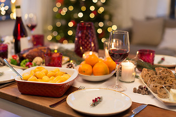 Image showing glass of red wine and food on christmas table