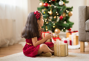 Image showing little girl with christmas gift at home