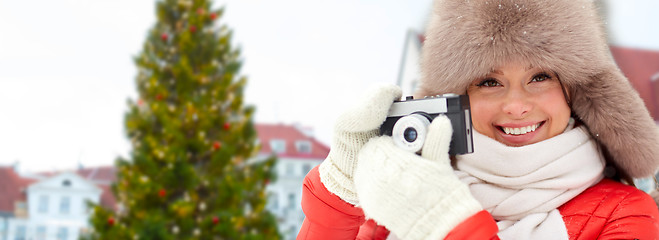 Image showing woman with camera over christmas tree in tallinn