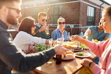 Image showing friends having dinner or bbq party on rooftop