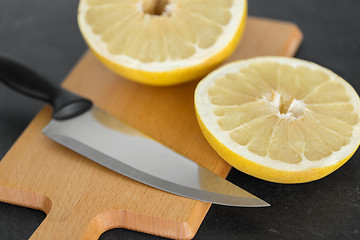 Image showing close up of lemon and knife on cutting board