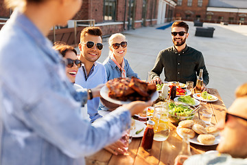 Image showing friends at barbecue party on rooftop in summer