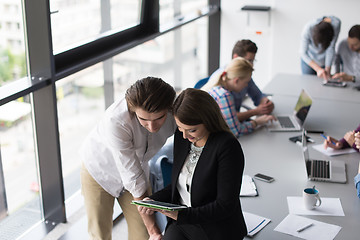 Image showing Two Business People Working With Tablet in office