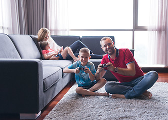 Image showing Happy family playing a video game