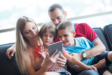 Image showing happy young couple spending time with kids