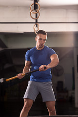 Image showing man workout with hammer and tractor tire