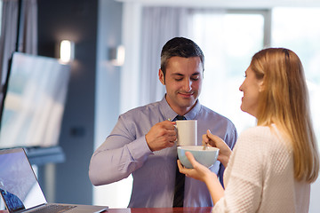 Image showing A young couple is preparing for a job and using a laptop