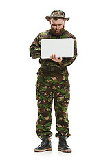 Image showing Young army soldier wearing camouflage uniform isolated on white