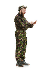 Image showing Young army soldier wearing camouflage uniform isolated on white