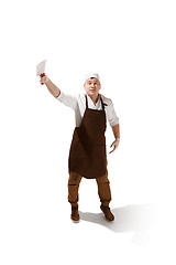 Image showing Smiling butcher jumping with a cleaver isolated on white background