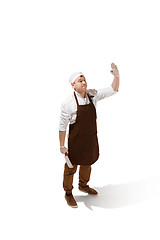 Image showing Smiling butcher jumping with a cleaver isolated on white background