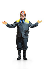 Image showing The studio shot of happy senior bearded male miner standing at the camera on a white background.