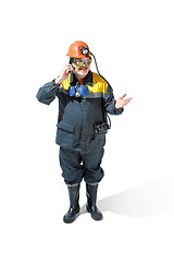 Image showing The studio shot of senior bearded male miner standing at the camera on a white background.