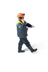 Image showing The studio shot of senior bearded male miner standing at the camera on a white background.