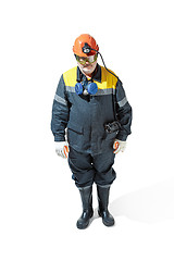 Image showing The studio shot of senior bearded male miner standing at the camera on a white background.