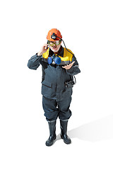 Image showing The studio shot of senior bearded male miner standing at the camera on a white background.