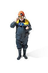 Image showing The studio shot of senior bearded male miner standing at the camera on a white background.