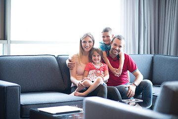 Image showing happy young couple spending time with kids