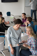 Image showing Pretty Businesswomen Using Tablet In Office Building during conf